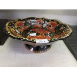 A ceramic black and red ground bowl with mythological design