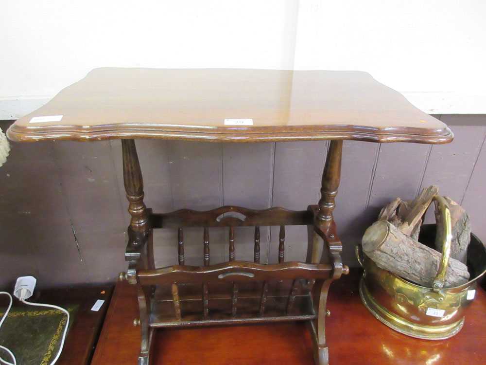 A reproduction mahogany occasional table with magazine rack to base
