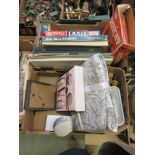 Two trays containing children's building blocks, board games, bedspreads, etc