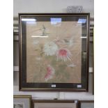 A framed and glazed oriental needlework of birds above flowers