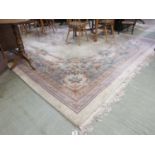 A large rectangular cream Chinese rug measuring 490cm by 322cm