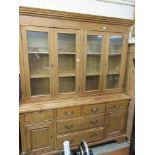 Pine dresser the cornice over 4 glazed doors, base with drawers and doors