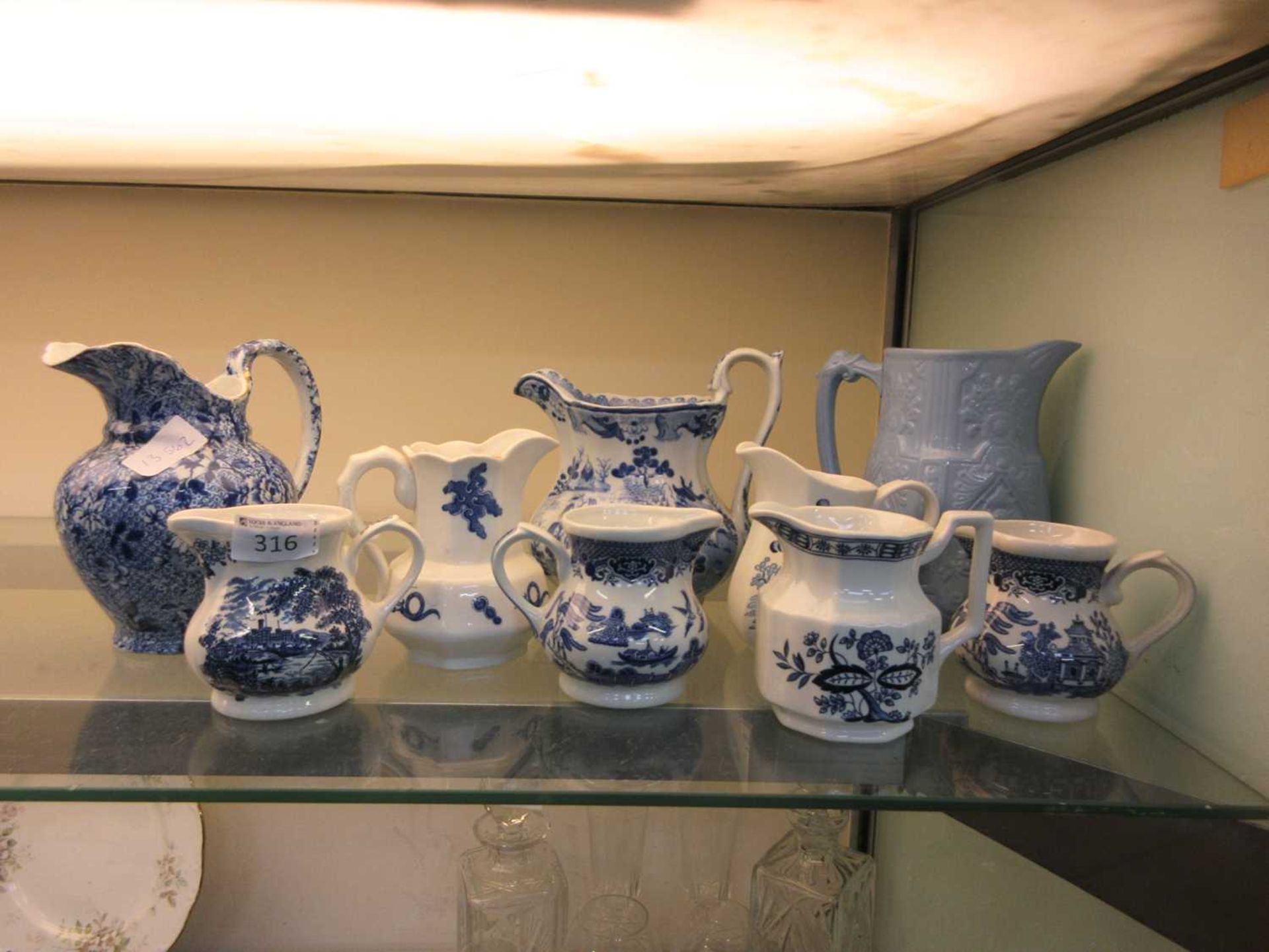A selection of blue and white ceramic pouring jugs