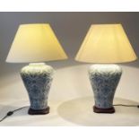 TABLE LAMPS, a pair, Chinese blue and white ceramic, of vase form with cream shades, 73cm H. (2)