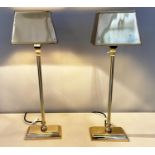 LIBRARY TABLE LAMPS, a pair, 60cm x 18cm x 13cm, gilt metal, with shades. (2)