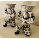 TRINKET DISHES, a pair, 33cm x 23cm x 18cm, in the form of Chinese men holding baskets. (2)