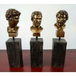 MINIATURE CLASSICAL BUSTS, three metallic finish on simulated wooden stands, 35cm H. (3)