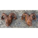 RAMS HEADS WALL RELIEFS, a pair, cast oxidised iron, 40cm x 28cm. (2)