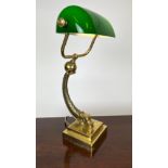 BANKERS LAMP, brass dolphin base with green glass shade, 47cm H.