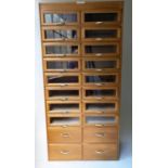 HABERDASHERY CABINET, mid 20th century oak and beech with sixteen glazed drawers by Corbett & Co