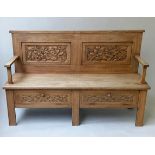 HALL SETTLE, early 20th century Arts and Crafts oak with carved panelled backs and drop front, 1905,