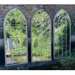 ARCHITECTURAL GARDEN MIRRORS, a set of three, aged metal frames, gothic style arch design, 160cm x