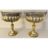 LARGE PEDESTAL URNS, gilt metal, twin handled form, pierced rims, 76cm high, 64cm diam.