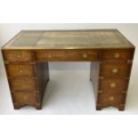 CAMPAIGN STYLE PEDESTAL DESK, mahogany and brass bound with gilt tooled leather and nine drawers