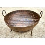 INDIAN KADAI FIRE PIT, 47cm high, 64cm wide, 60cm diameter, two handled form, raised on supports