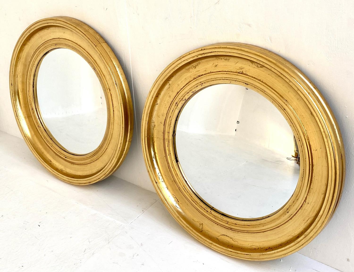 CONVEX BUTLER WALL MIRRORS, a pair, Regency style, gilt frames, 74cm x 74cm. (2)