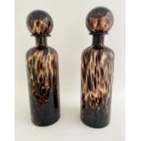 DECANTERS, a pair, Murano style tortoise shell pattern glass, 40cm x 10cm. (2)