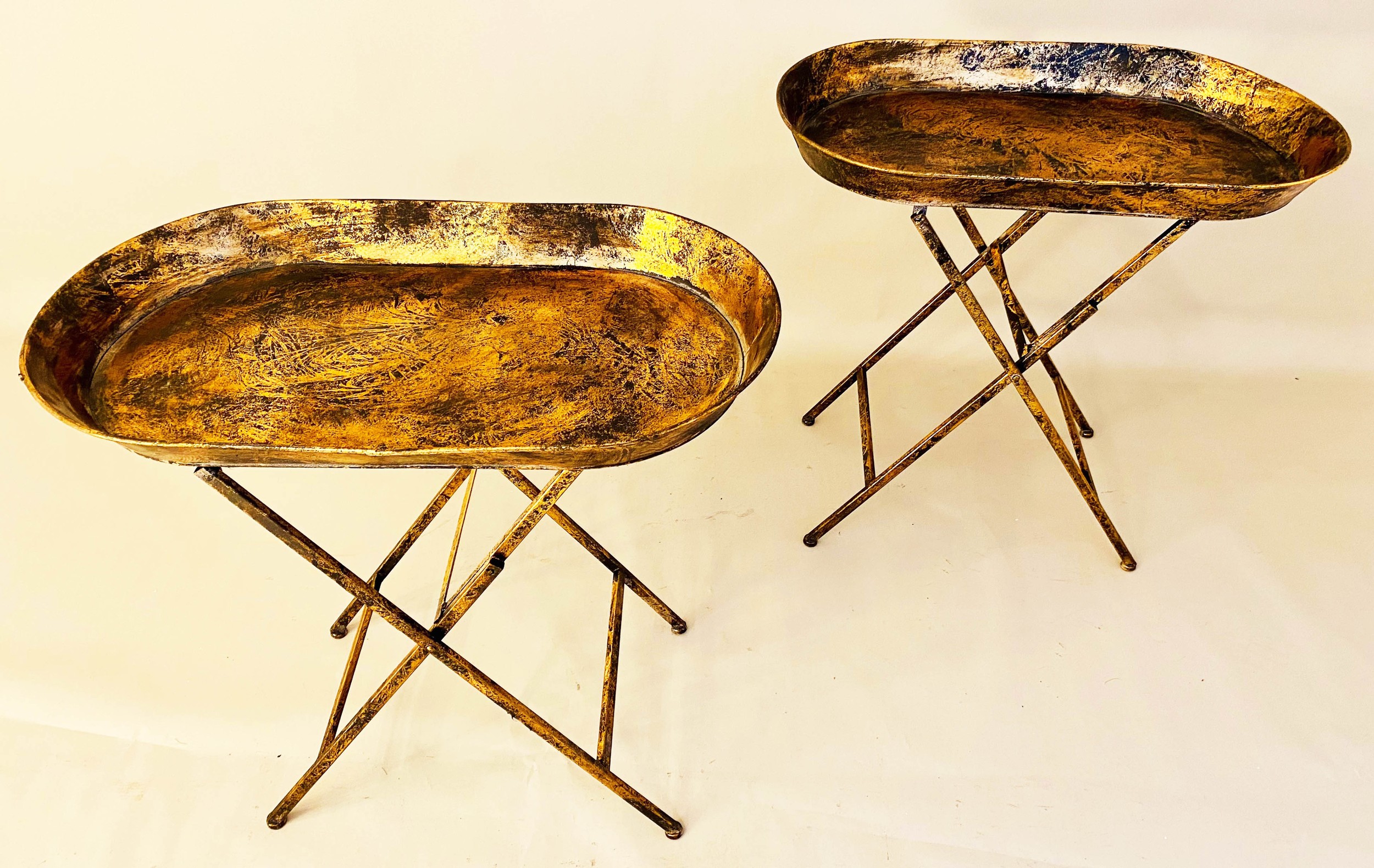 TRAY TABLES, a pair, gilt metal, fold out base 66cm x 69cm x 39cm. (2)