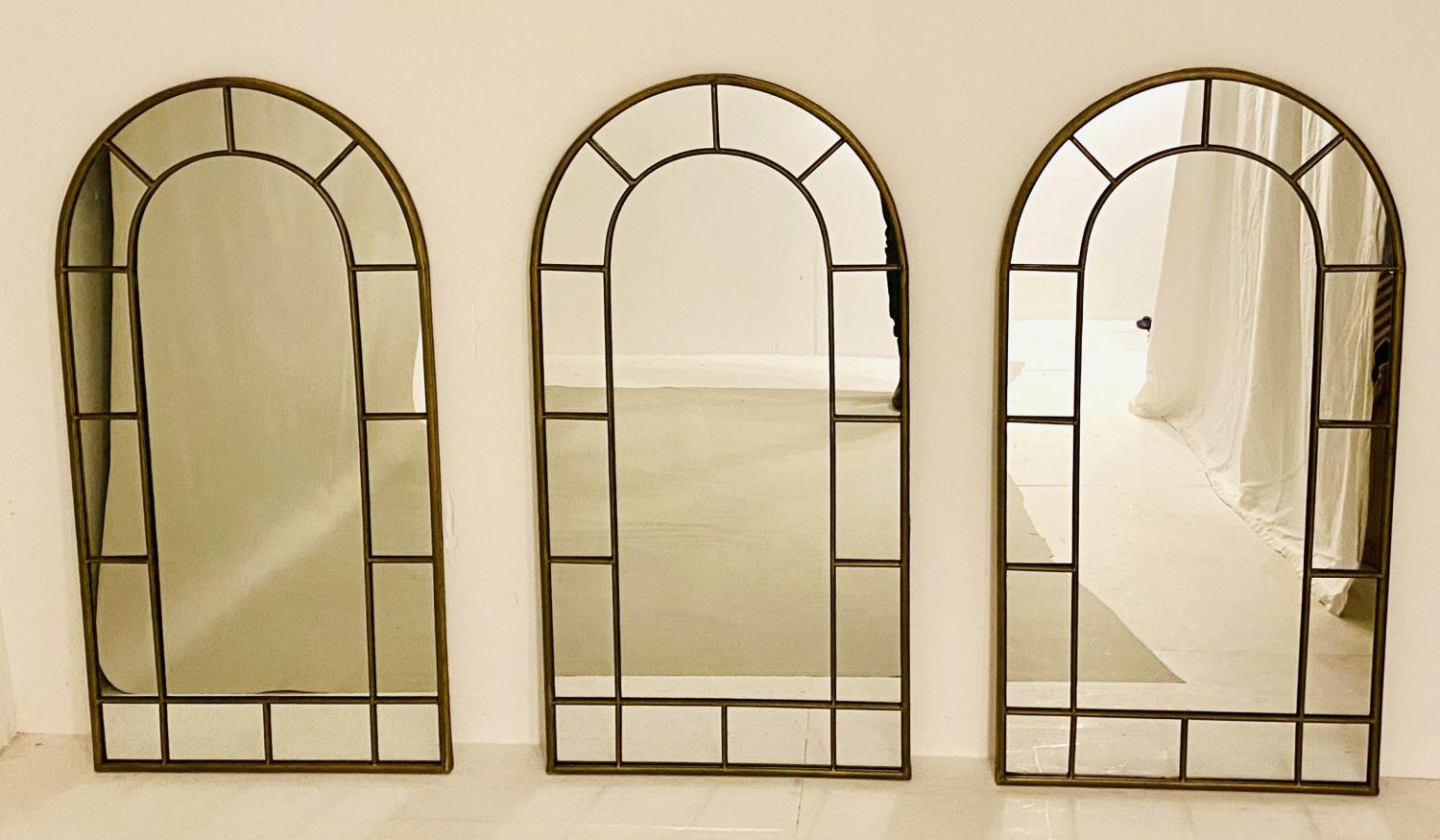 ARCHITECTURAL WALL MIRRORS, a set of 3, Regency style, bronzed finish arched frames, 107cm x