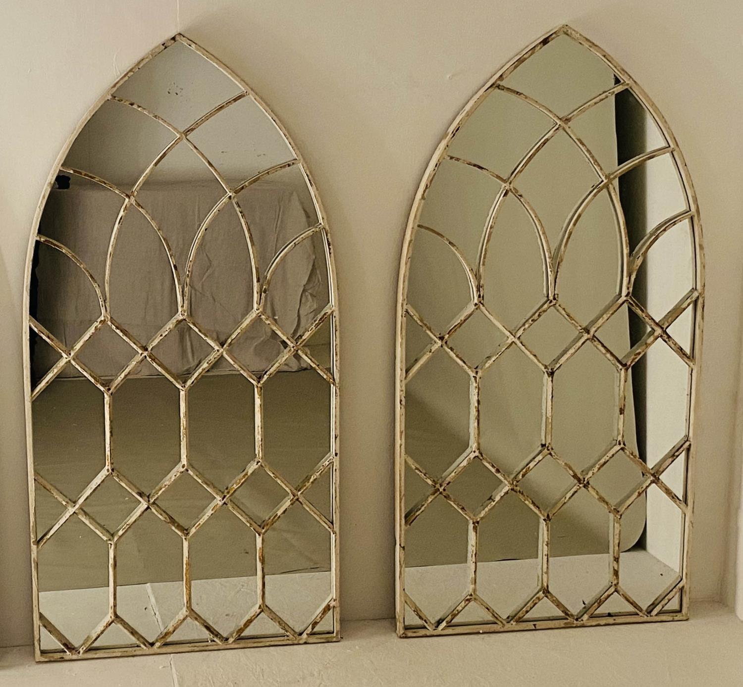 ARCHITECTURAL WALL MIRRORS, a pair, Moorish style arched design, aged white painted, 132cm x