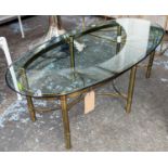 LOW TABLE, 42cm H, the oval glass top on a brass base.