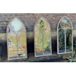 ARCHITECTURAL GARDEN MIRRORS, a set of three, Gothic style, aged metal frames, 122cm x 56cm. (3)