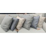 CUSHIONS, three pairs, in differing designs, each approx 50cm x 50cm. (6)