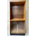 HABERDASHERY DISPLAY CABINET, mid 20th century oak, with open shelved cabinet above two sliding