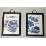 CHINESE WALL PLAQUES, a pair, blue/white ceramic, framed, 29cm x 37cm. (2)