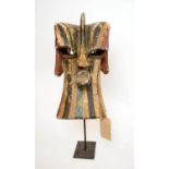 SONGYE MASK, carved and painted wood, green, red and black, Congo, on metal stand, 50cm x 36cm.