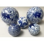 CHINESE SPHERES, ceramic blue and white two large depicting elephants and three smaller, largest