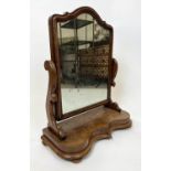 VANITY MIRROR, Victorian flame mahogany, arched top with moulded edge on bun feet, 80cm H x 65cm W.