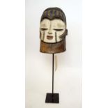 IGALA MASK, painted and carved wood, blue, white and red, Nigeria, on metal stand, 38cm x 24cm.