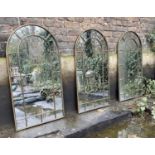 ARCHITECTURAL GARDEN MIRRORS, a set of three, arched bronzed metal frames, 107cm x 55cm. (3)