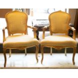 FAUTEUILS, a pair, each 60cm W x 91cm H, Louis XV style, gilt painted in patterned cream fabric. (2)