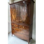 LINEN PRESS, George III period flame mahogany with trays, drawers and well splayed swept supports,