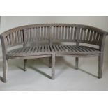 BANANA GARDEN BENCH, weathered slatted teak with bowed back and arms, 160cm W.