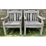 GARDEN ARMCHAIRS, a pair, silvery weathered teak of substantial slatted construction with carved