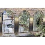 ARCHITECTURAL GARDEN MIRRORS, a set of three, arched bronzed metal frames, 107cm x 55cm. (3)