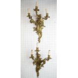 WALL LIGHTS, a pair, Louis XV style Rococo design gilt metal, three branch, 60cm H x 35cm. (2)