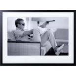 AFTER JOHN DOWNING, Steve McQueen with gun, 54cm x 74cm, framed and glazed.