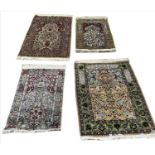 HEREKE SILK RUGS, a collection of four, largest 119cm x 82cm.