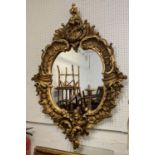 WALL MIRROR, 88cm x 132cm H, 19th century Continental giltwood in Rococo style with oval plate.