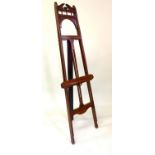 EASEL, Edwardian Liberty style walnut with carved and pierced frame work and adjustable ledge, 178cm