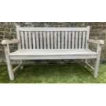 GARDEN BENCH, silvery weathered teak of slatted form by Joe Alexander, 150cm W.