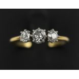 AN 18CT GOLD THREE STONE DIAMOND RING, brilliant cut stones, comprising central stone of approx. 0.