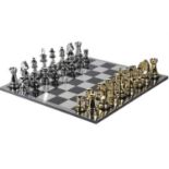 CHESS SET, with oversized pieces in silvered and gilt finish, 60x60.