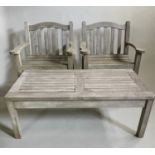 GARDEN ARMCHAIRS AND TABLE, a pair substantial silvery weathered teak with flat top arms, and shaped