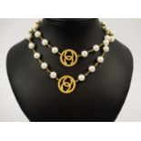 CHANEL NECKLACE, faux pearl and gold tone, with gold tone Chanel logo roundels, total length 78cm
