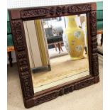 MIRROR, 19th century Indian, square intricately carved surround with bevelled plate, 64cm x 64cm.